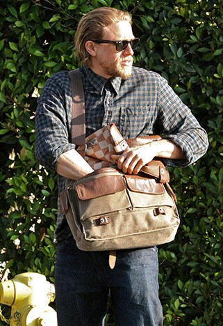 charlie hunnam with a messenger bag