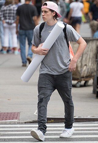 Brooklyn Beckham on the street in backwards cap grey t-shirt