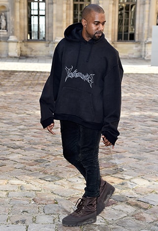 Kanye West wearing black jeans and black hoodie