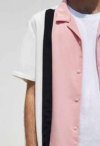 ASOSer wearing a pink bowling shirt with navy shorts and white sneakers | ASOS Style Feed