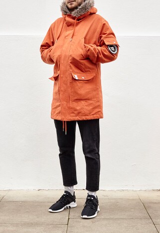 Miles in orange fur-lined parka