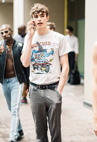 New York Fashion Week street styler wearing a graphic tee and neat grey trousers | ASOS Style Feed
