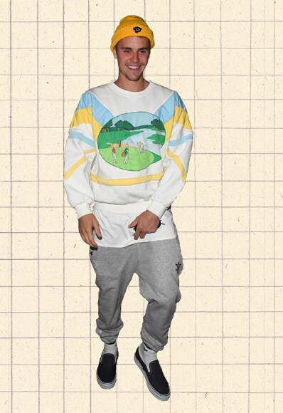 Justin Bieber wearing an 80s-inspired novelty sweatshirt, grey joggers and black slip-on plimsolls | ASOS Style Feed