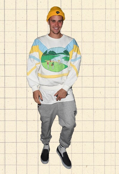 Justin Bieber wearing an 80s-inspired novelty sweatshirt, grey joggers and black slip-on plimsolls | ASOS Style Feed