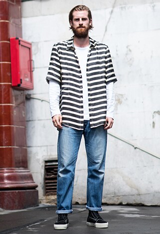 Street-styler wearing a white, long-sleeved tee under a striped shirt with jeans and black high-tops | ASOS Style Feed