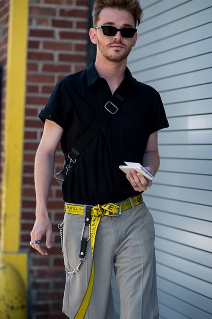 New York Fashion Week street-styler wearing a polo top, trousers, sunglasses and an Off-White belt | ASOS Style Feed