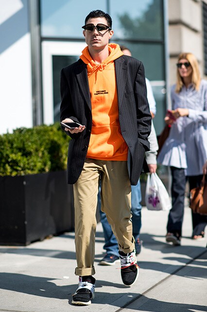 New York Fashion Week street-styler wearing an orange hoodie, pinstripe blazer, chinos and Off-White x Nike Air Presto trainers | ASOS Style Feed