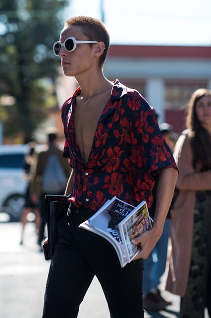 MFW SS18 Street Style featuring a street styler in a floral-print short-sleeved shirt, black jeans and oval-shaped sunglasses | ASOS Style Feed