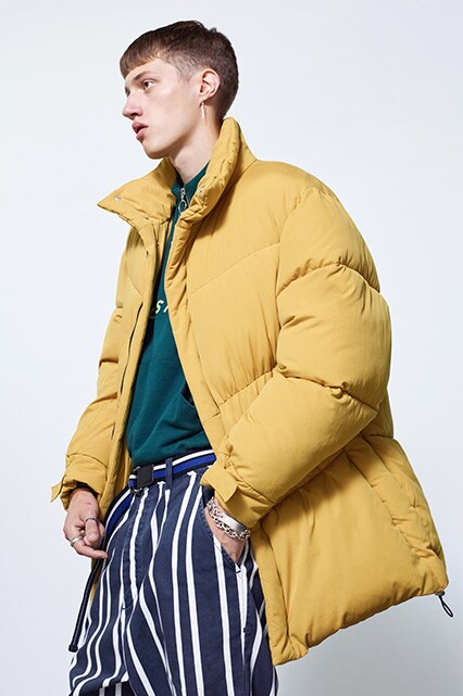 Model wearing an oversized puffer jacket, a half-zip top, cropped trousers and white sneakers | ASOS Style Feed
