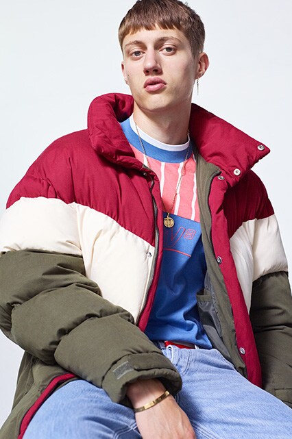 Model wearing a high-necked T-shirt, stonewashed jeans and an oversized puffer jacket | ASOS Style Feed