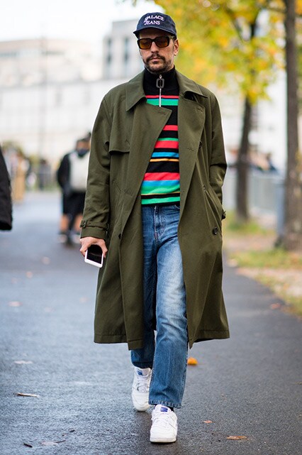 PFW SS18 Street Style featuring a street styler wearing a Palace cap, J.W.Anderson half-zip top, a khaki trench coat, jeans and Gosha Rubchinskiy Reebok trainers  | ASOS Style Feed