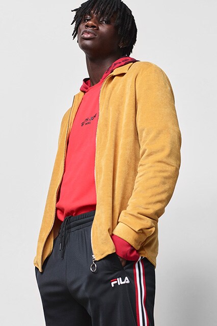 ASOS model wearing a mustard tracksuit top, a red Sixth June hoodie, fila tracksuit bottoms and Reebok Workout trainers | ASOS Style Feed