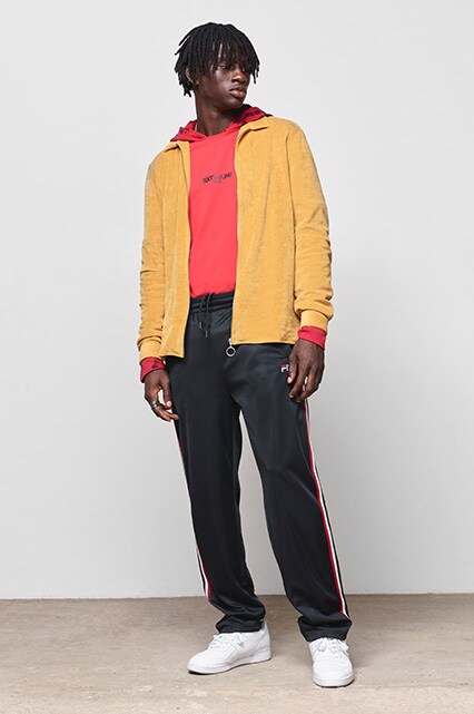 ASOS model wearing a mustard tracksuit top, a red Sixth June hoodie, fila tracksuit bottoms and Reebok Workout trainers | ASOS Style Feed