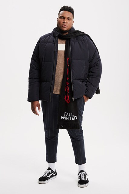 ASOS model wearing a black puffer jacket, brown jumper, Sixth June scarf and Vans Old Skool trainers | ASOS Style Feed