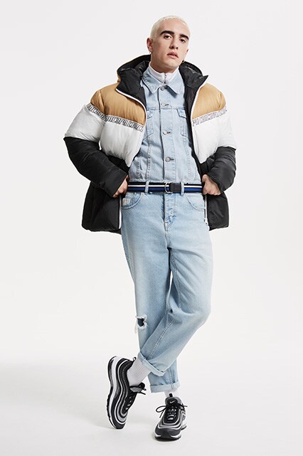 ASOS model wearing a puffer jacket, white half-zip, denim jacket, jeans, striped belt and Nike Air Max 97 UI '17 trainers | ASOS Style Feed