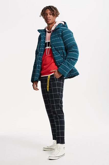 ASOS model wearing a puffer jacket, pink hoodie, check trousers and Converse trainers | ASOS Style Feed