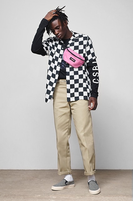 Model wearing stone coloured work pants, a checkerboard-print shirt and houndstooth slip-on shoes | ASOS Style Feed