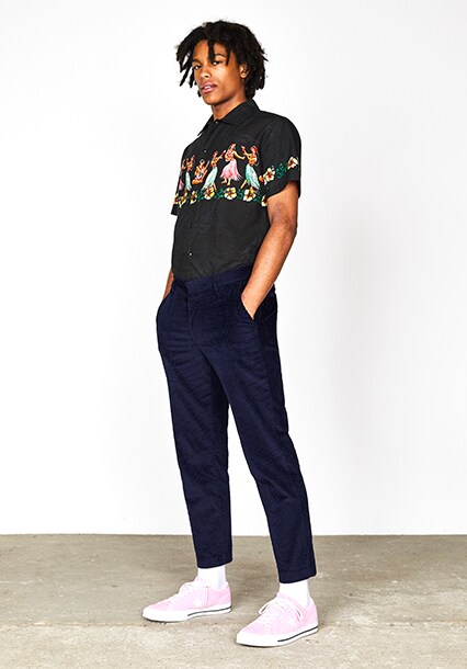 ASOS model wearing a black printed shirt, navy cropped trousers and pink Converse One Star OX trainers | ASOS Style Feed