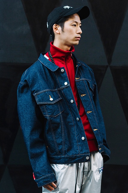 A street-styler wearing a denim jacket, half-zip jumper and metallic joggers | ASOS Style Feed