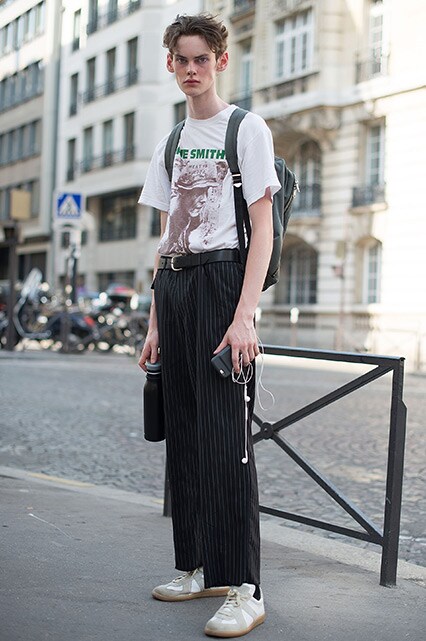 A street-styler wearing a The Smiths T-shirt, pinstripe trousers and white adidas trainers | ASOS Style Feed