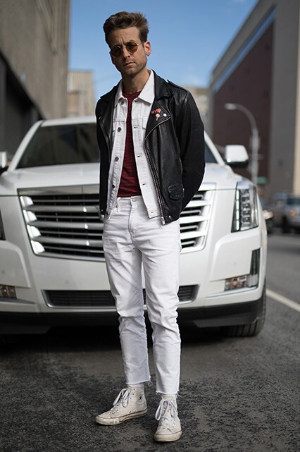 A street-styler wearing a white denim jacket and jeans, a striped T-shirt, a leather jacket and shades | ASOS Style Feed