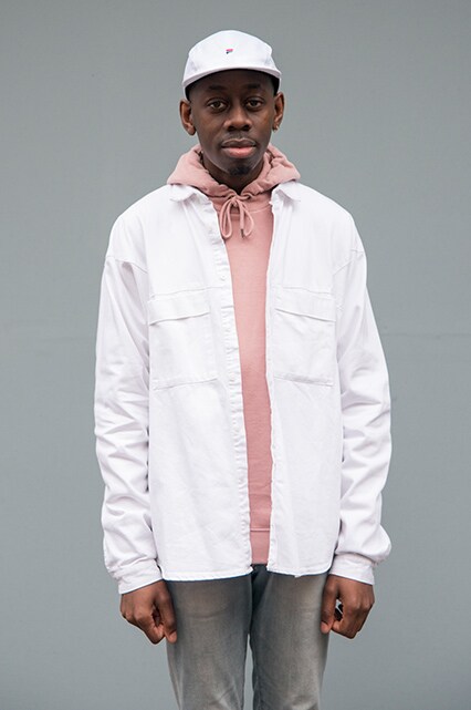 A street-styler wearing a pink hoodie, white denim chore jacket, white cap and slim-fit jeans | ASOS Style Feed