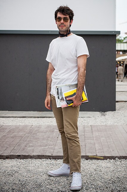 A street-styler wearing a white T-shirt, beige jeans, Converse trainers, retro sunglasses and a scarf | ASOS Style Feed