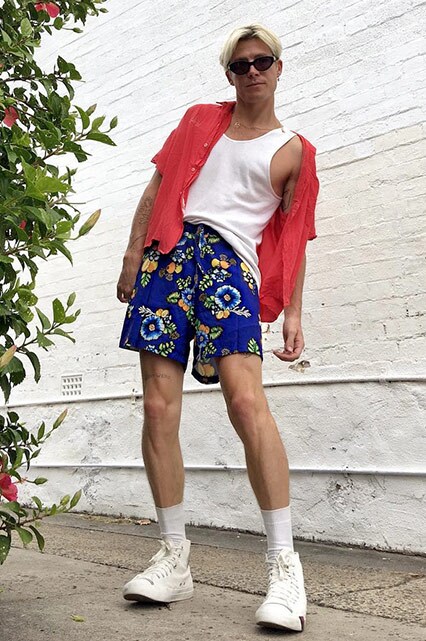 ASOS Insider Jono wearing a white vest, red short-sleeved shirt, shades, ASOS Made In Kenya shorts and white trainers | ASOS Style Feed