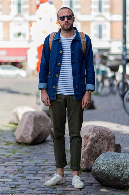 A street-styler wearing a denim jacket, stripe T-shirt, shades, chinos and Converse trainers | ASOS Style Feed