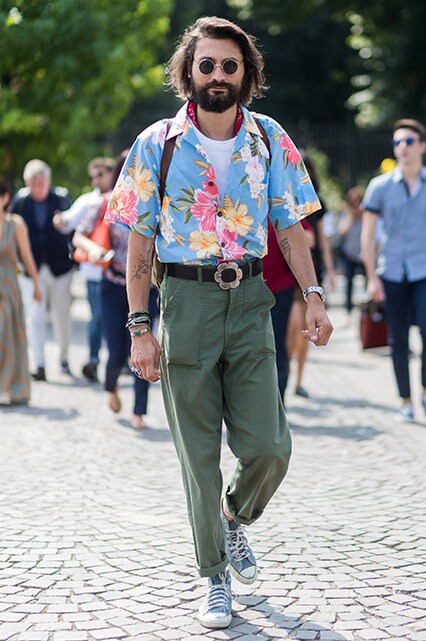 A street styler wearing round sunglasses, a Hawaiian-print short-sleeved shirt, chinos and Converse | ASOS Style Feed