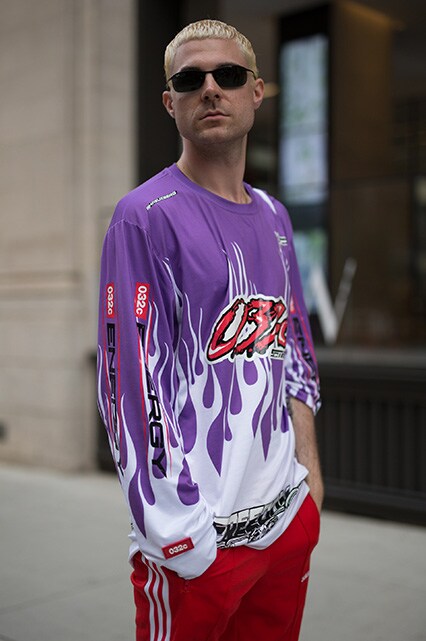 A street-styler wearing a long-sleeved graphic-print top, adidas joggers and shades | ASOS Style Feed