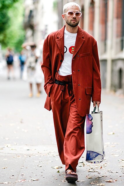 A street-styler wearing a graphic-print T-shirt, a suit, sandals and shades | ASOS Style Feed