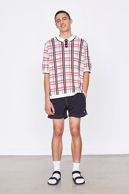 A model wearing a check polo shirt, shorts, socks and sandals available on ASOS | ASOS Style Feed