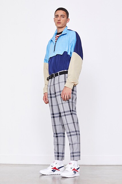 A model wearing a striped T-shirt, a colour-block track jacket, check trousers and Reebok Classic trainers available at ASOS | ASOS Style Feed
