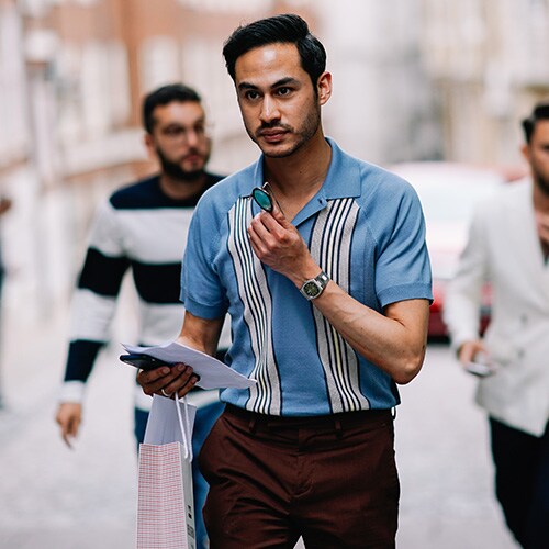 A street-styler wearing a striped polo shirt | ASOS Style Feed 