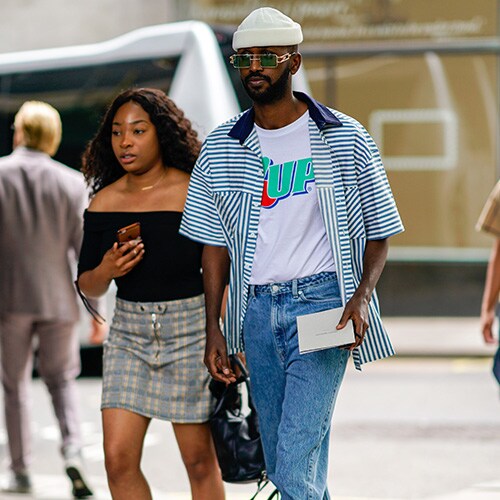 A street-styler wearing a logo-print T-shirt, striped shirt and shorts | ASOS Style Feed