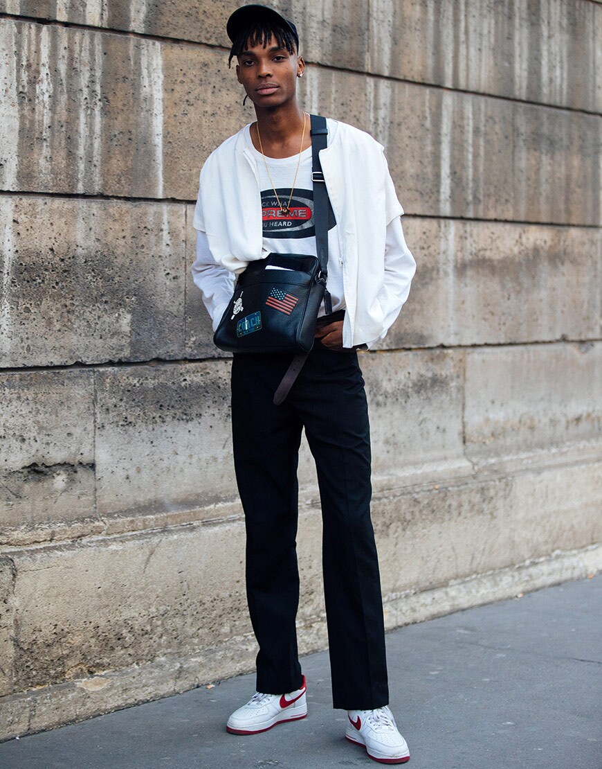 A model wearing a cap, a white top, a cross-body bag, jeans and Nike trainers | ASOS Style Feed