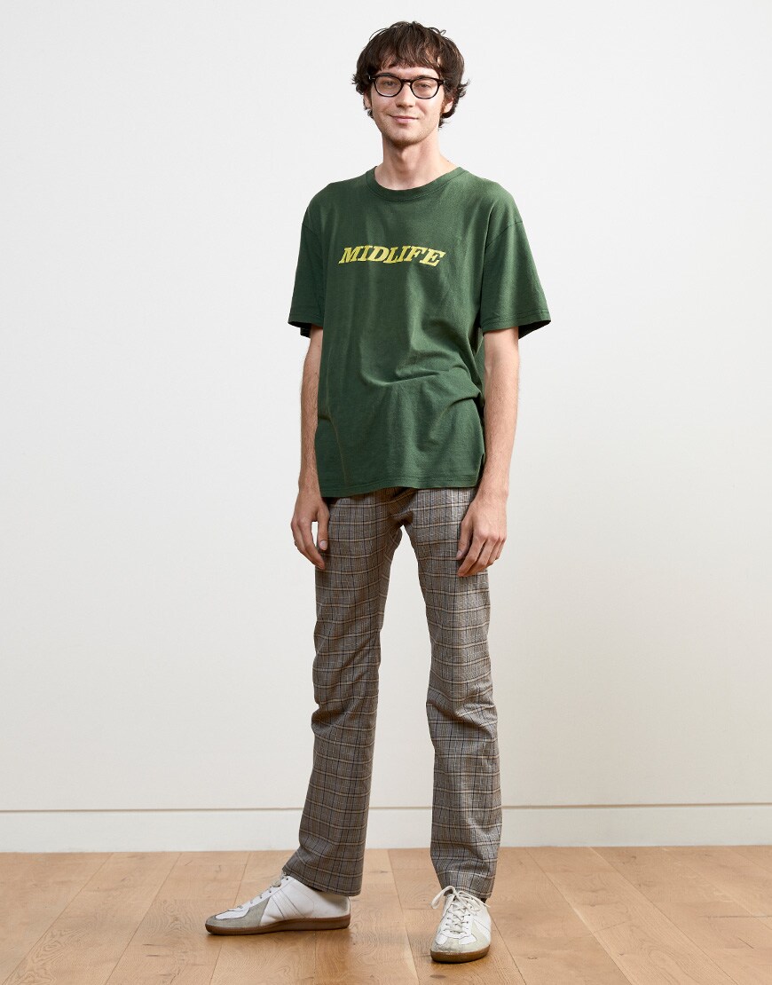 Warren wearing a graphic-print T-shirt, plaid trousers and white trainers | ASOS Style Feed