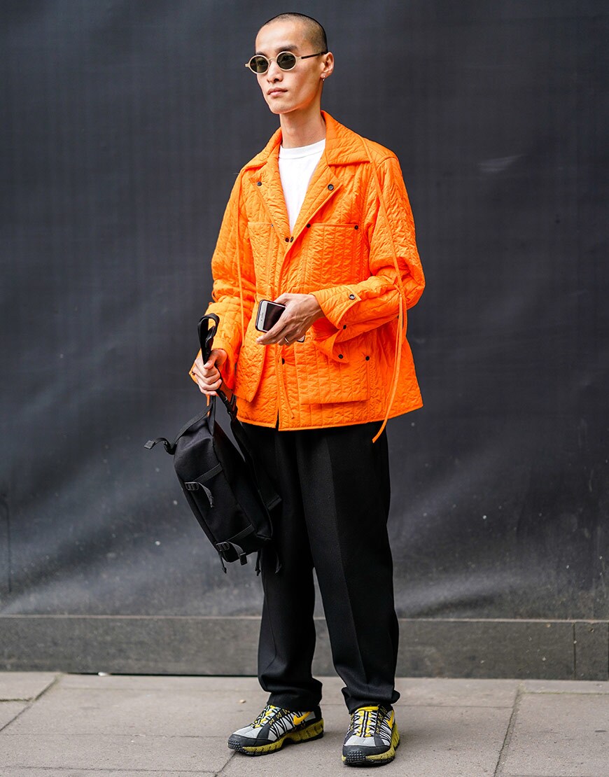 A street-styler wearing a white T-shirt and an orange jacket | ASOS Style Feed