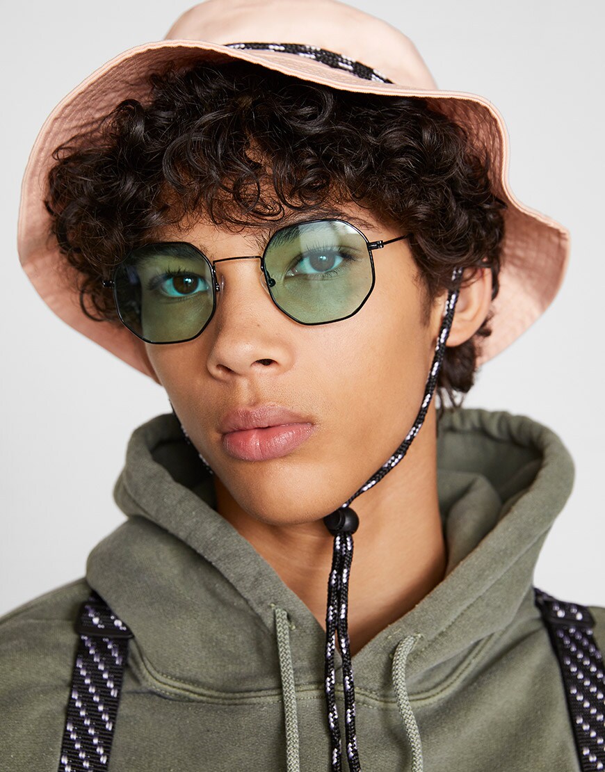 A model wearing a khaki co-ord, retro shades and a pink bucket hat | ASOS Style Feed
