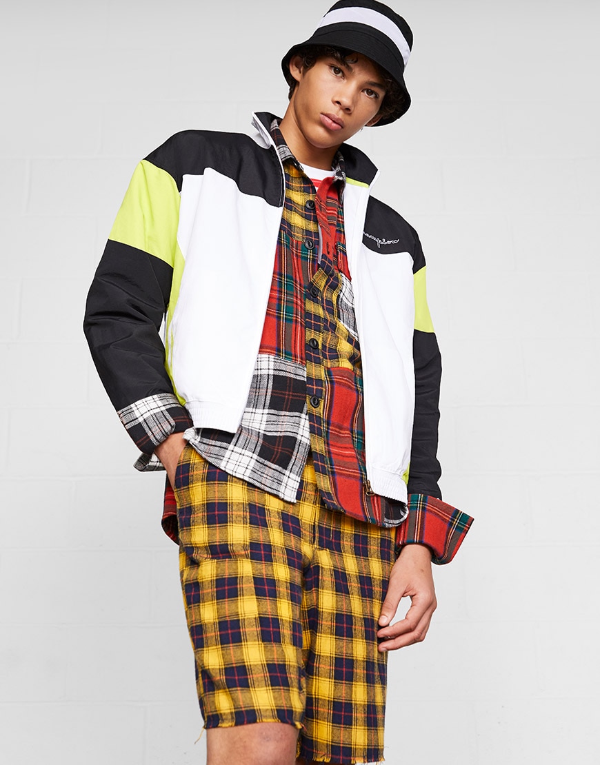 A model wearing a check co-ord, bucket hat and fluorescent jacket | ASOS Style Feed 