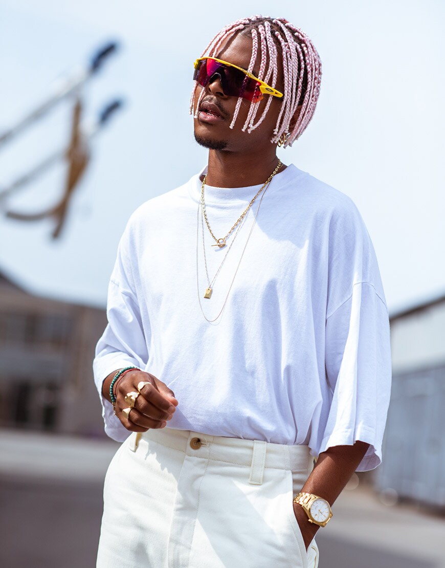 A street-styler wearing a white T-shirt and cream trousers | ASOS Style Feed