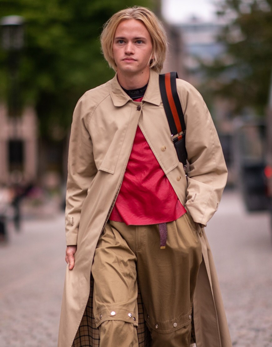 A street-styler wearing a camel coat and red T-shirt | ASOS Style Feed