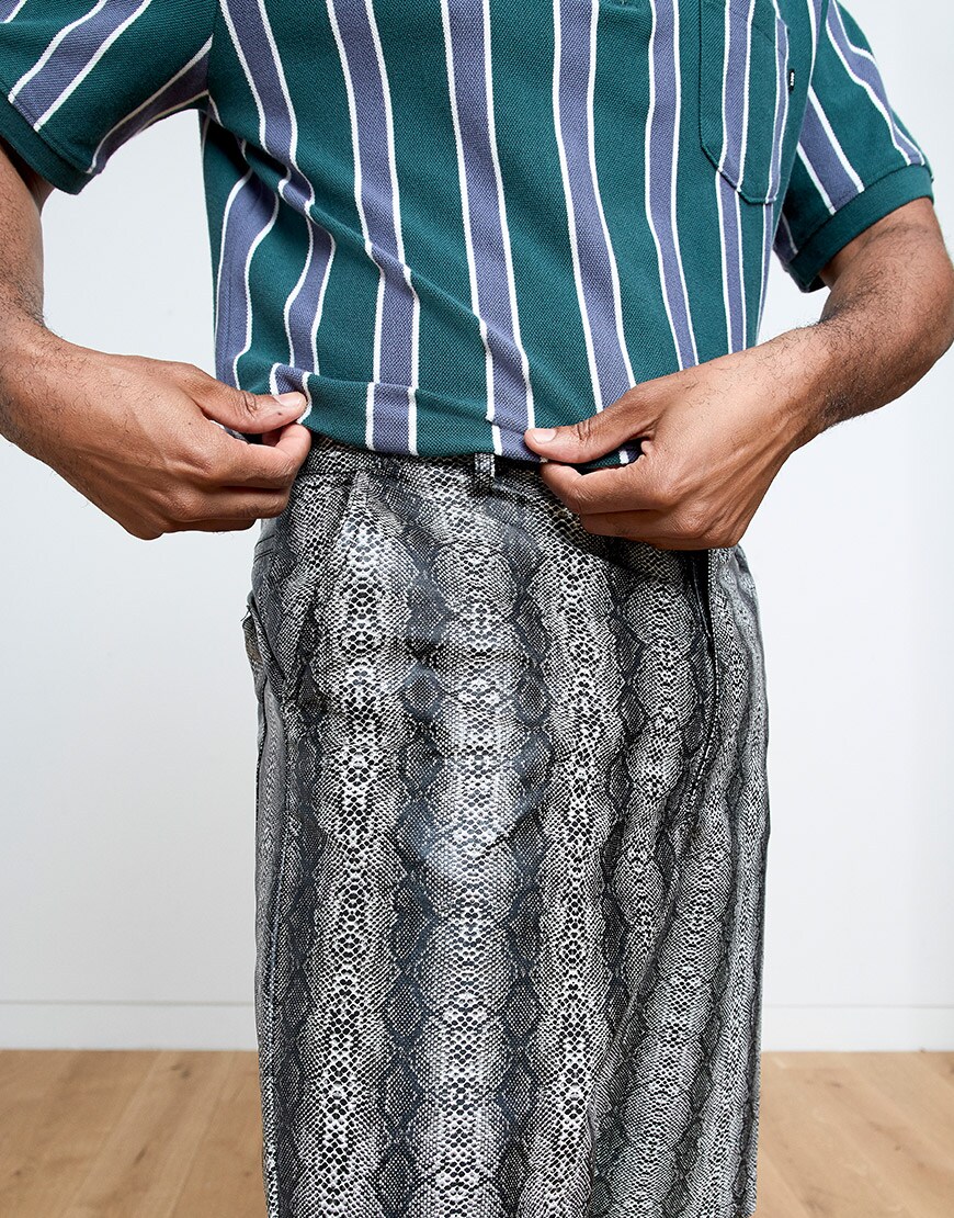 A close-up of Cobbie's shorts and striped polo shirt | ASOS Style Feed