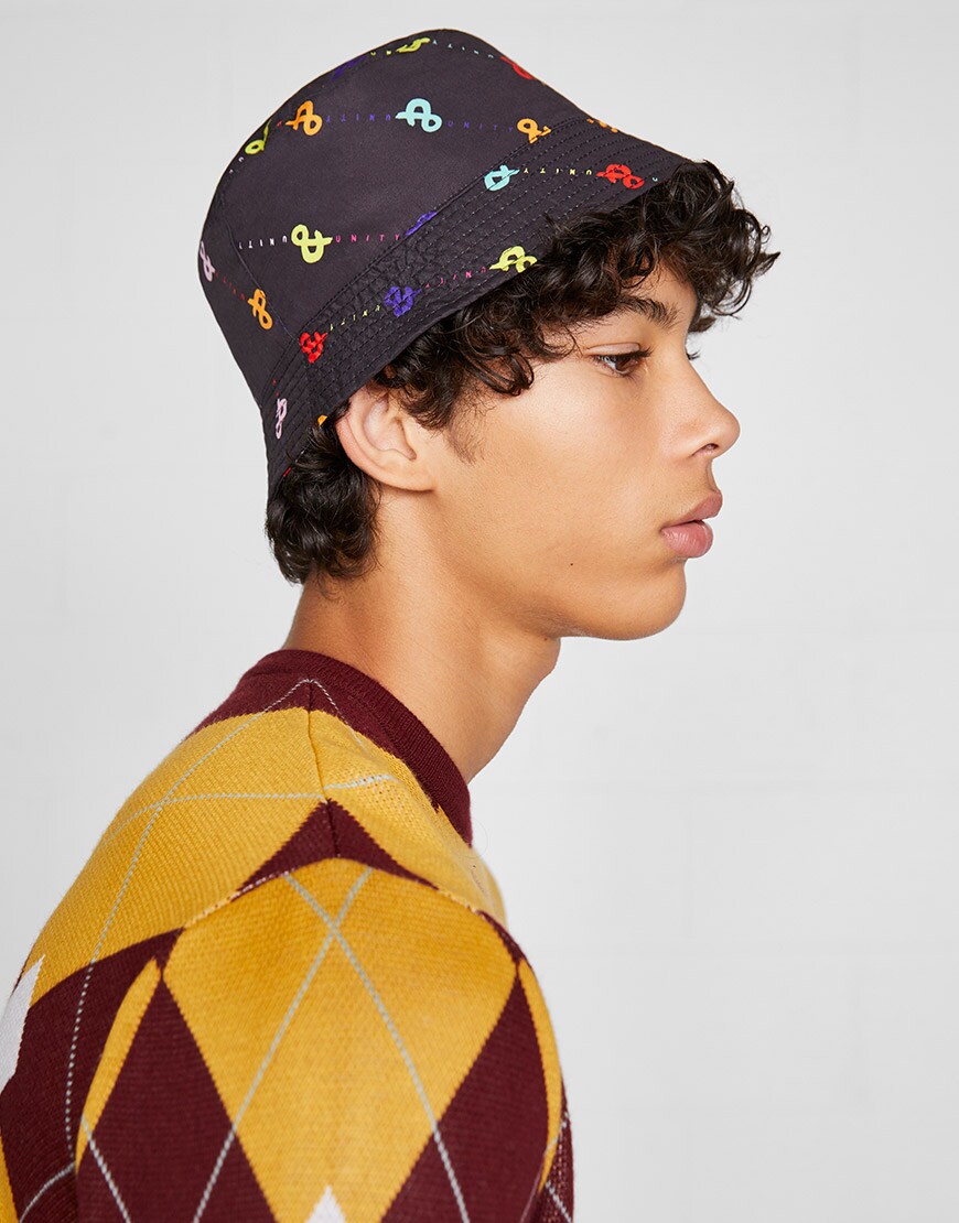 An ASOS model wearing a diamond-print jumper and a bucket hat | ASOS Style Feed
