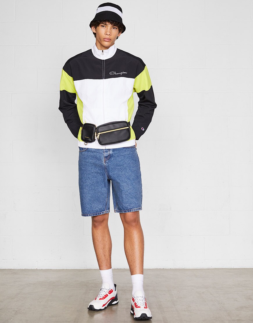 A model wearing a colour-block track jacket, denim shorts, chunky trainers, a bucket hat and a bum bag | ASOS Style Feed