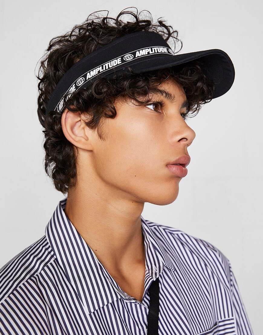 A model wearing a striped shirt and a visor | ASOS Style Feed