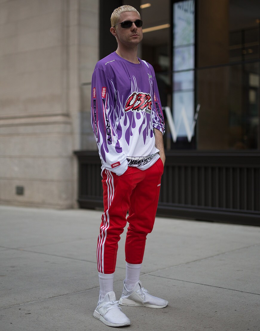 A street-styler wearing shades, adidas tracksuit bottoms and a 032c graphic-print top | ASOS Style Feed