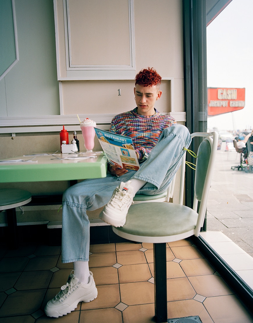 Olly Alexander in a striped jumper, jeans and Fila Disruptor trainers for ASOS Magazine | ASOS Style Feed