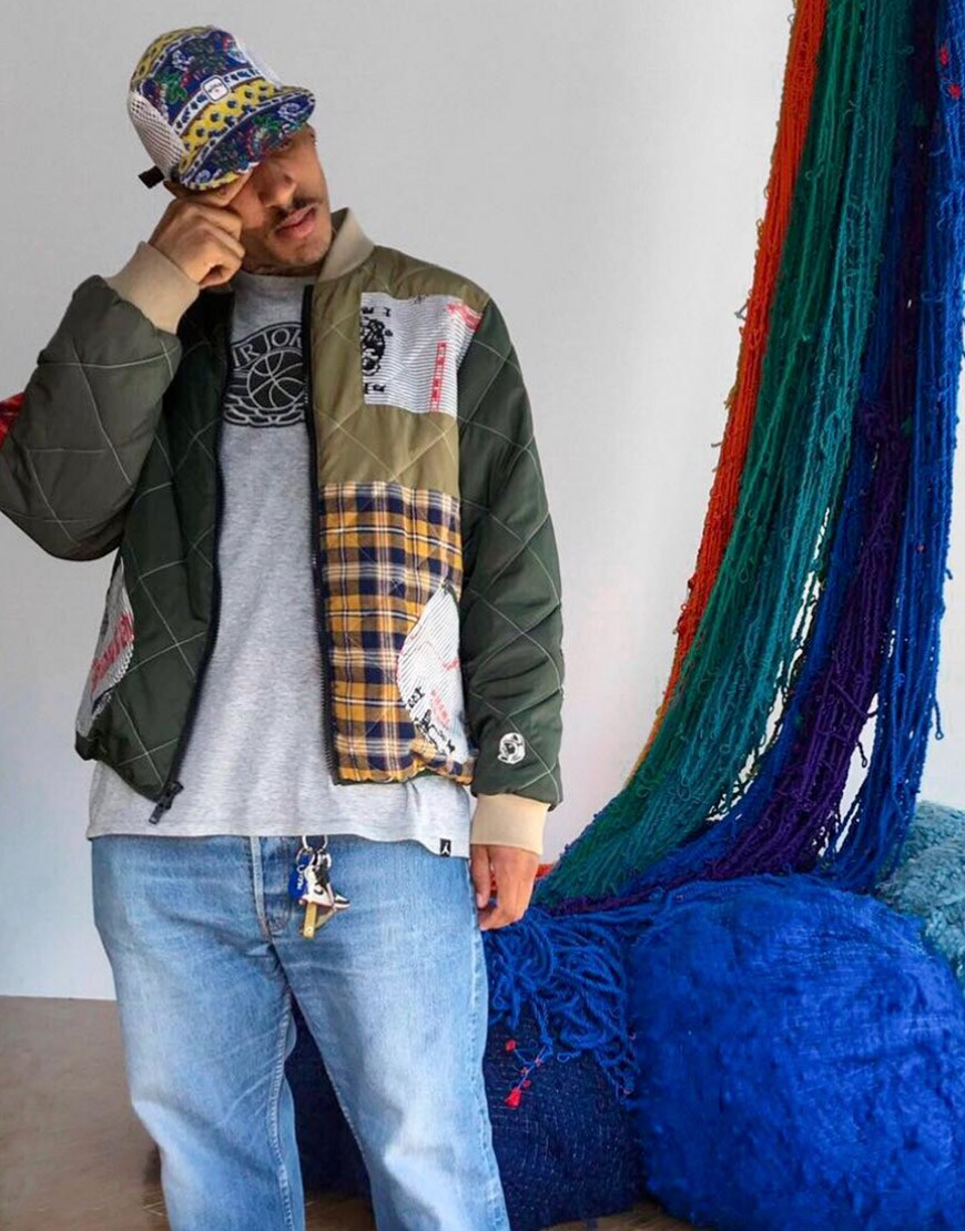@asos_ruddy wearing a patterned bomber jacket, jeans, graphic-print T-shirt and multi-print cap | ASOS Style Feed